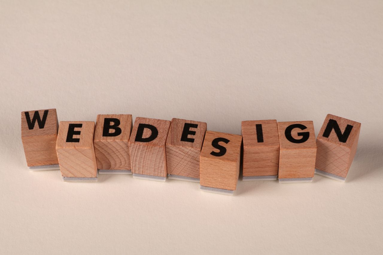 about-us Wooden blocks spelling web design creatively showcase digital design concept.